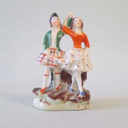 A miniature Staffordshire figure of Scottish dancers.  Circa 1880