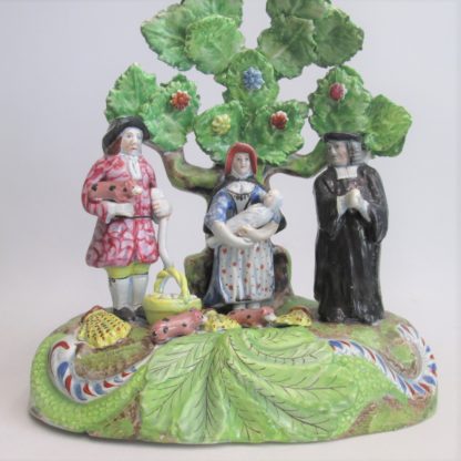 A Staffordshire pearlware 'Tythe Pig' group, depicting the farmer, holding a pig with other produce of bushels of corn and his wife holding a baby.   Circa 1820 - Image 2