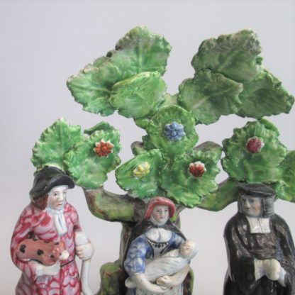 A Staffordshire pearlware 'Tythe Pig' group, depicting the farmer, holding a pig with other produce of bushels of corn and his wife holding a baby.   Circa 1820 - Image 3