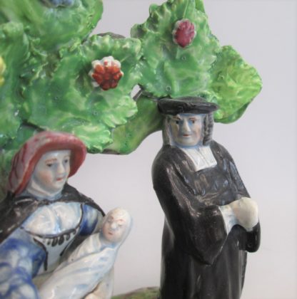 A Staffordshire pearlware 'Tythe Pig' group, depicting the farmer, holding a pig with other produce of bushels of corn and his wife holding a baby.   Circa 1820 - Image 4