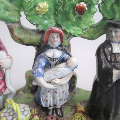 A Staffordshire pearlware 'Tythe Pig' group, depicting the farmer, holding a pig with other produce of bushels of corn and his wife holding a baby.   Circa 1820 - Image 5