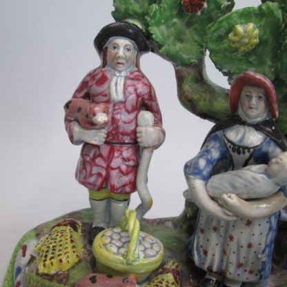 A Staffordshire pearlware 'Tythe Pig' group, depicting the farmer, holding a pig with other produce of bushels of corn and his wife holding a baby.   Circa 1820 - Image 6